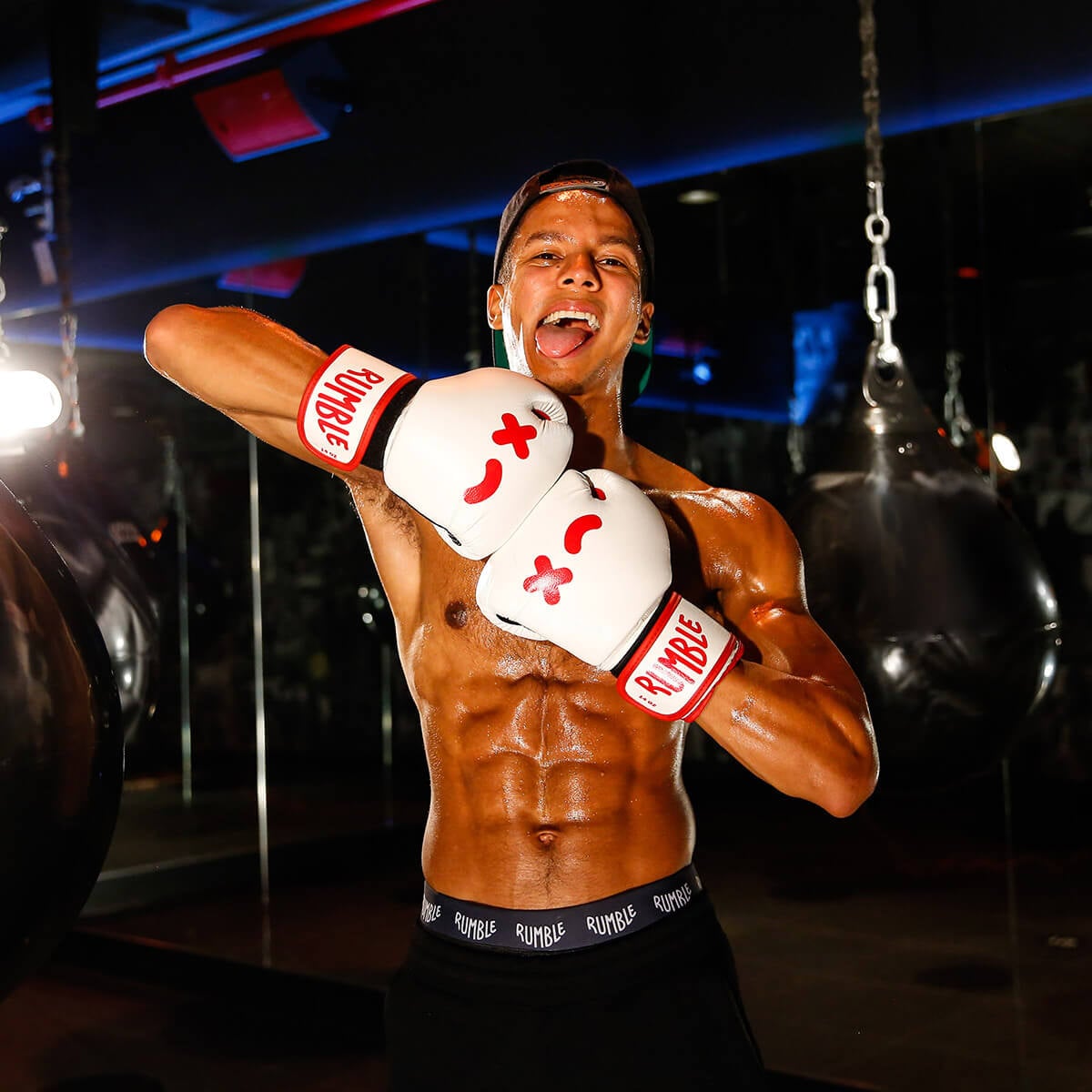 Person posing with Rumble boxing gloves